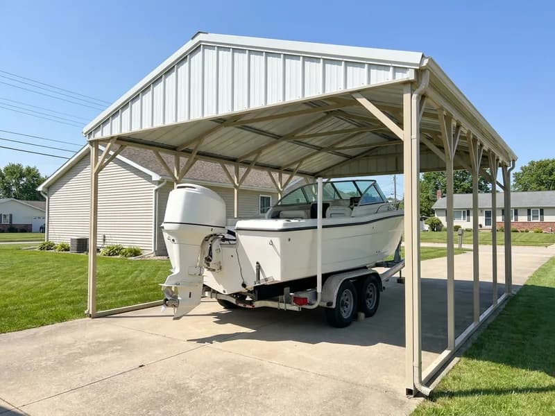 Center console boat on its trailer parked under a steel carport with a gable roof and clearance on all sides