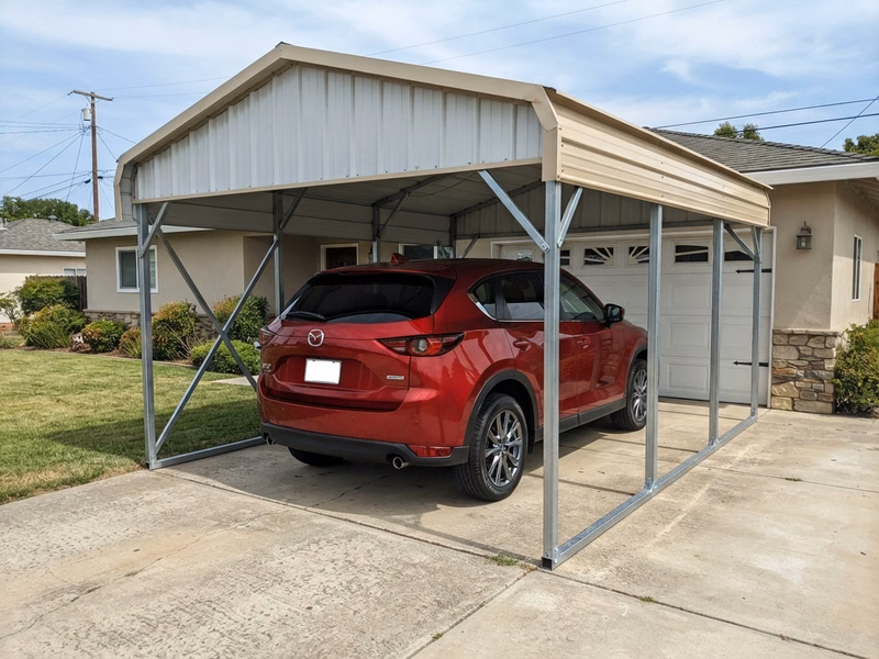 2022 Mazda CX-5 parked under a vertical-roof galvanized steel metal carport beside a ranch-style house